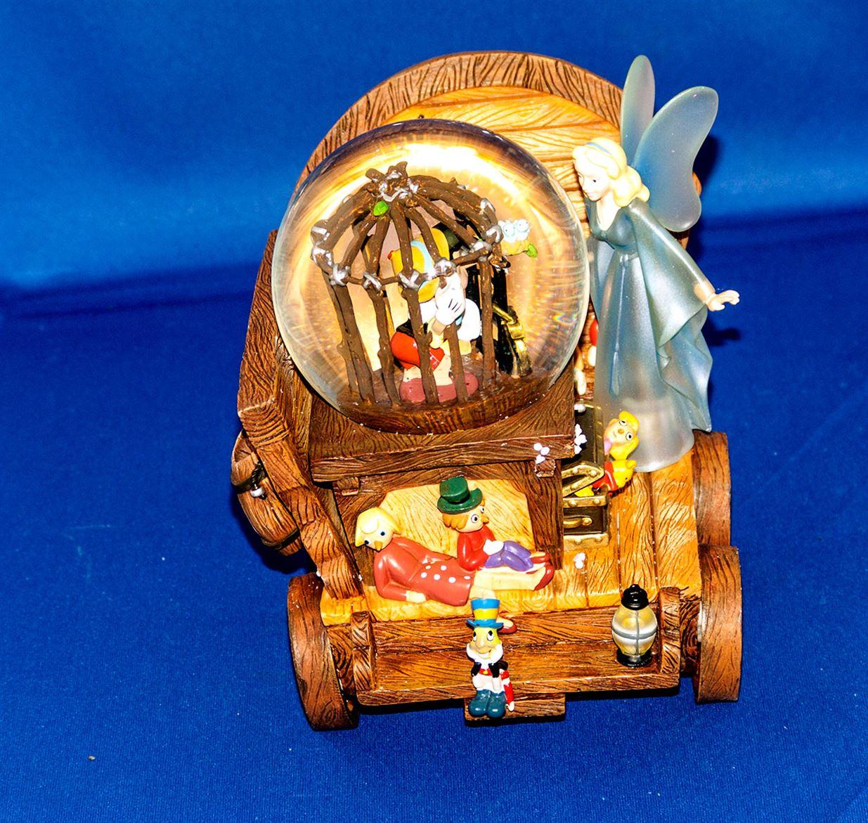 Rare Pinocchio music snow globe wagon