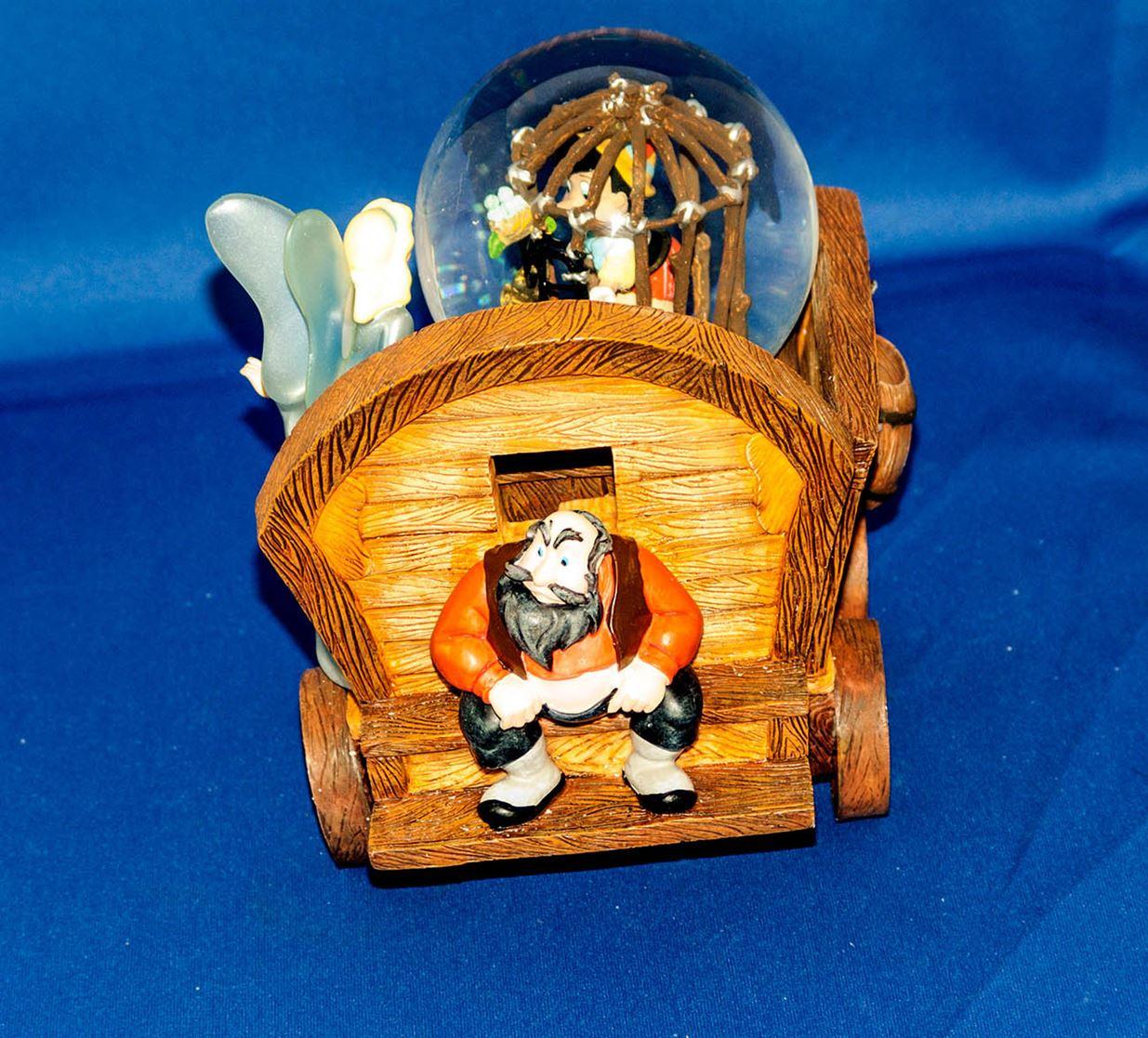 Rare Pinocchio music snow globe wagon