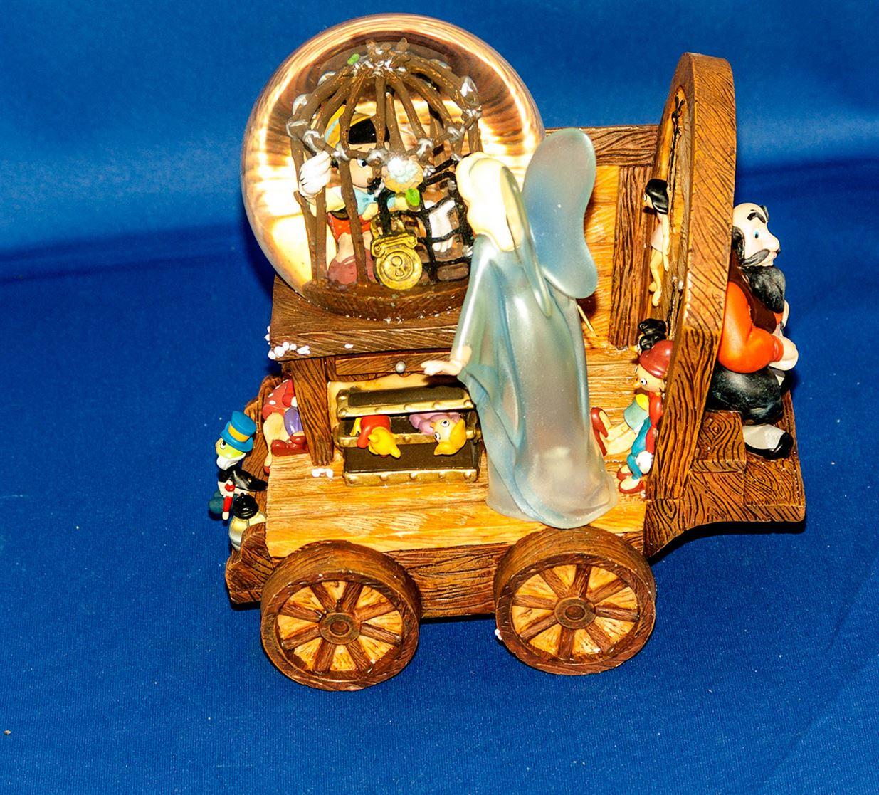 Rare Pinocchio music snow globe wagon